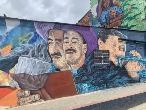 Murals of people drinking, reading and playing music